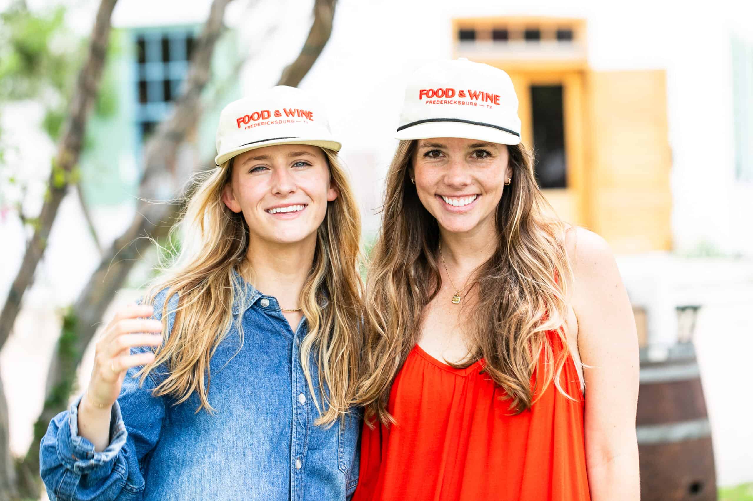 Two women in Fredericksburg Food & Wine Festival hats