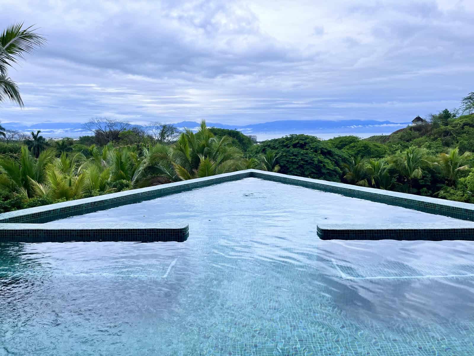 View of the ocean and mountains from an infinity hot tub