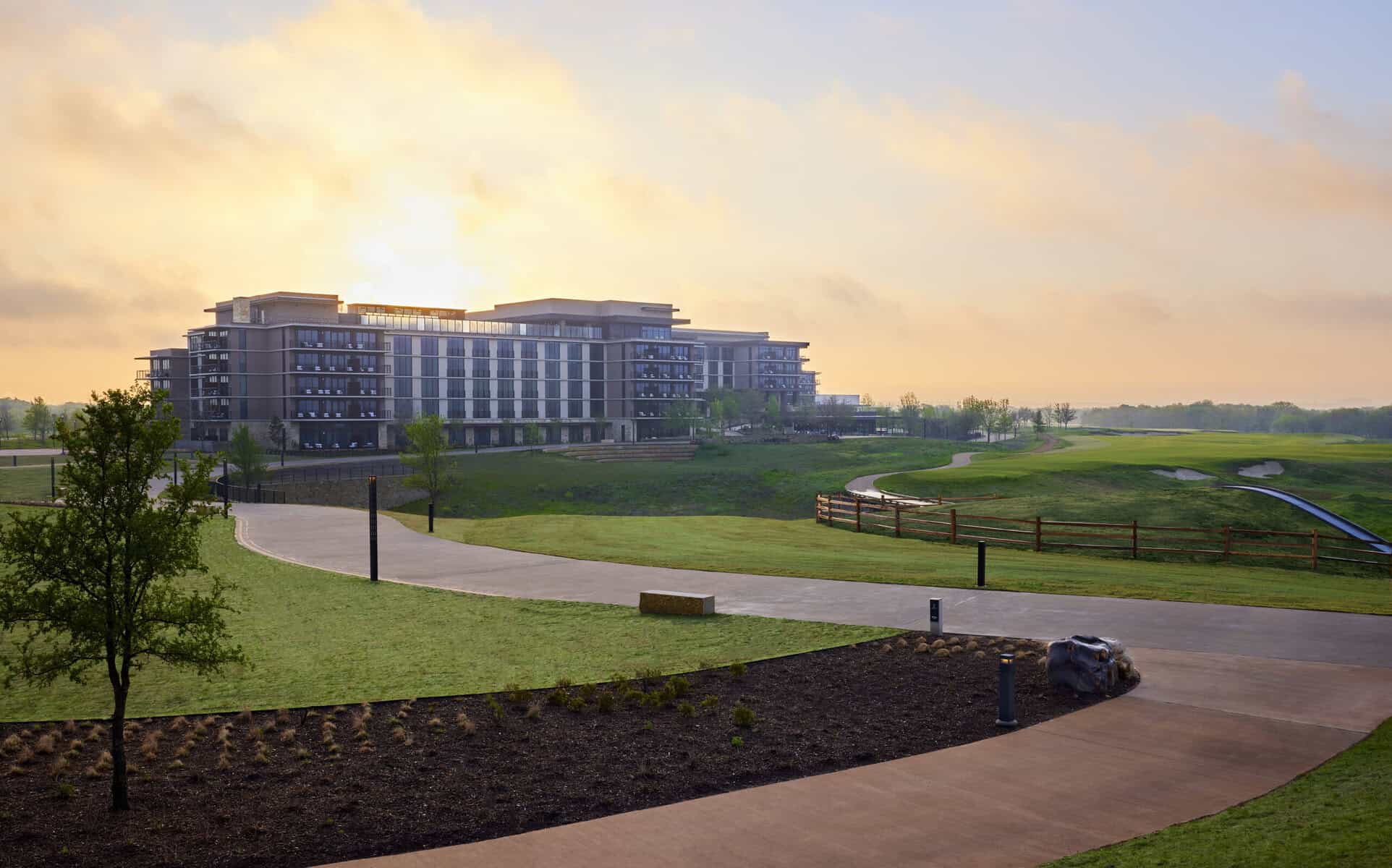 Luxury hotel on scenic golf course at sunrise in Texas.