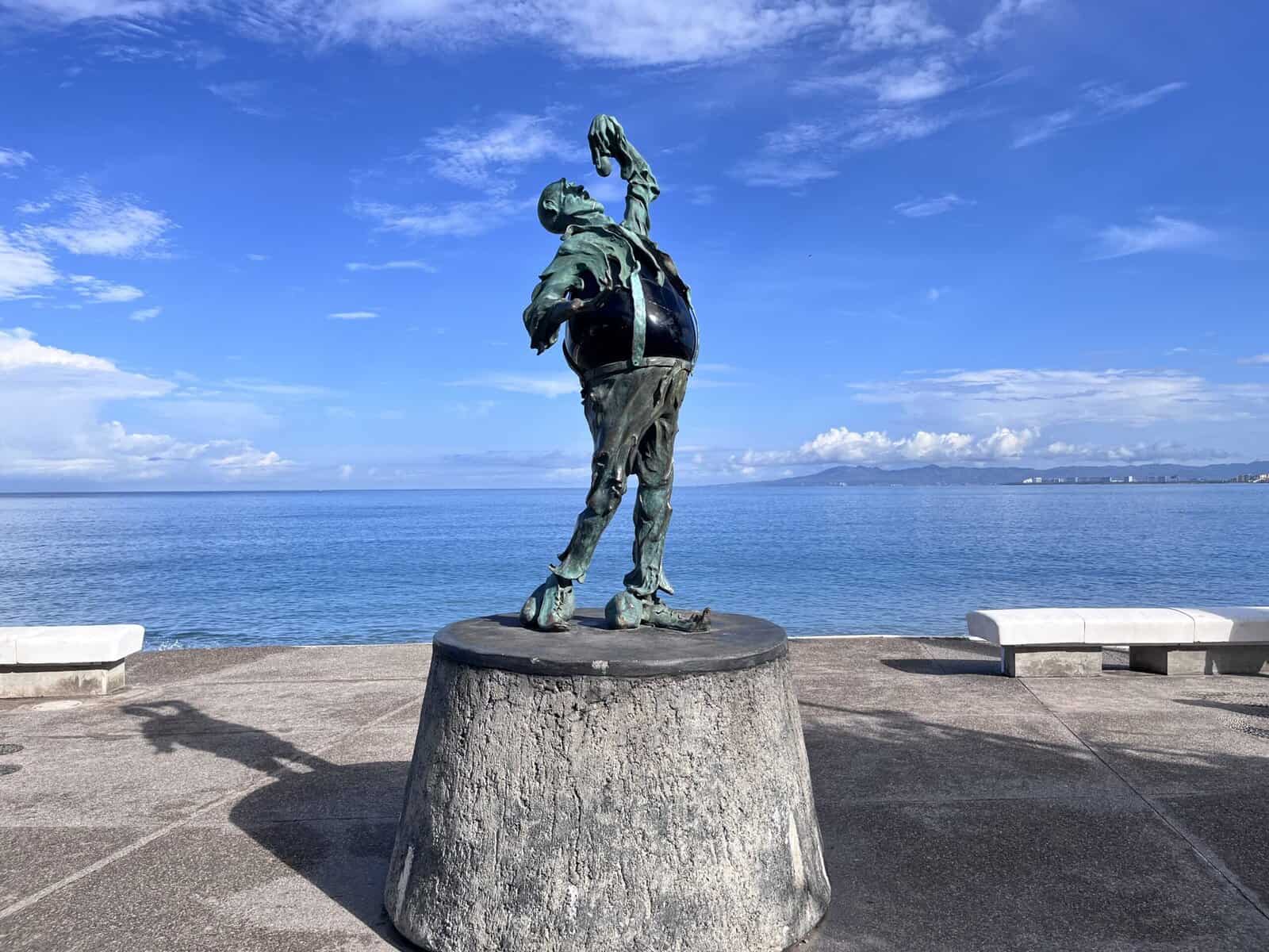 Sculpture of a man swallowing a light bulb 