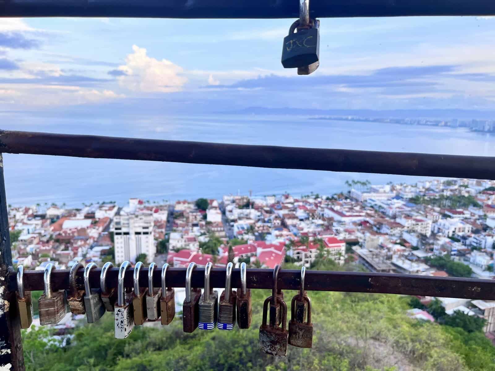 Locks attached to a rail overlooking the ocean
