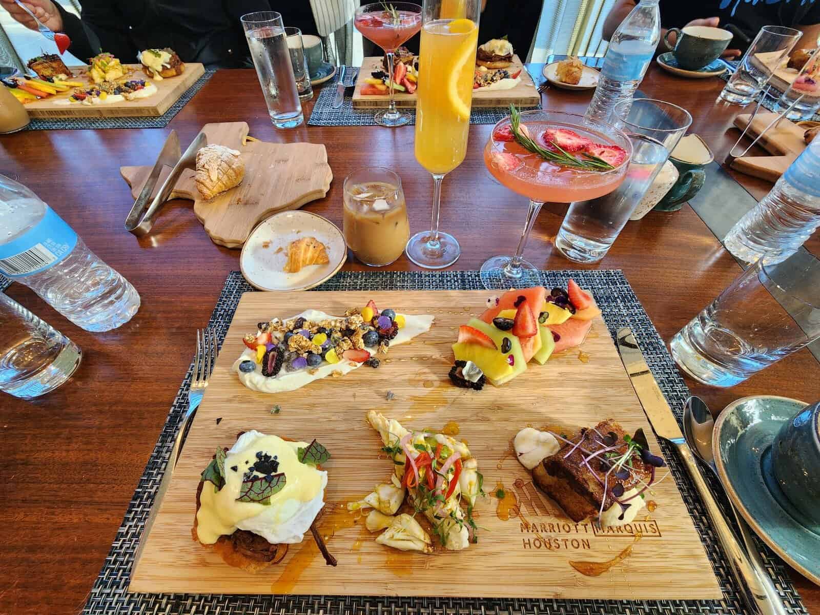 An array of breakfast foods on a wooden table.