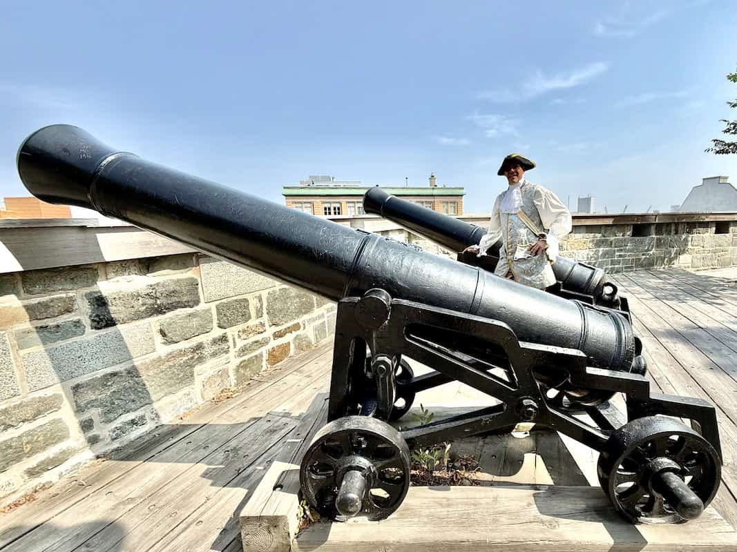 Guide Sylvain Girard stands beside historic cannons on Old Quebec’s fortified city wall.