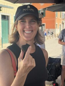 Woman examining truffles at a Croatian market with chef.