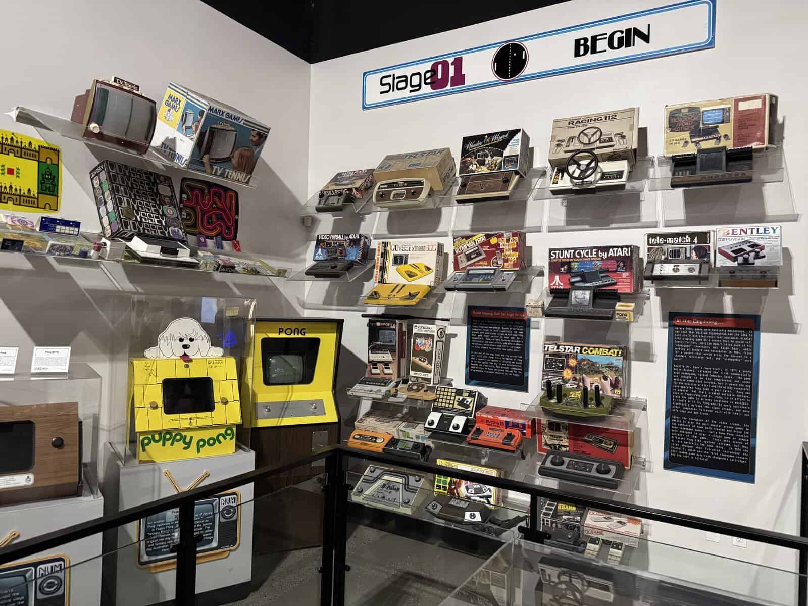 A collection of classic video game systems and games, including Puppy Pong and Stunt Cycle by Atari.