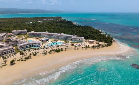 Aerial view of Secrets and Dreams Playa Esmeralda resort in Miches, Dominican Republic, showing the beachfront pools, white sand, and turquoise ocean.
