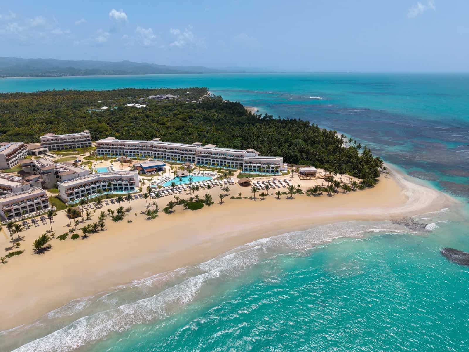 Aerial view of Secrets and Dreams Playa Esmeralda resort in Miches, Dominican Republic, showing the beachfront pools, white sand, and turquoise ocean.