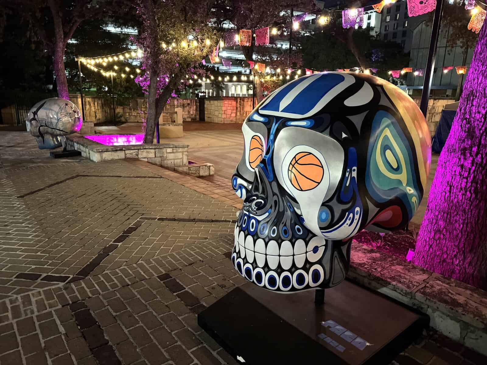 A blue and black skull featuring smiling teeth and basketball eyes.