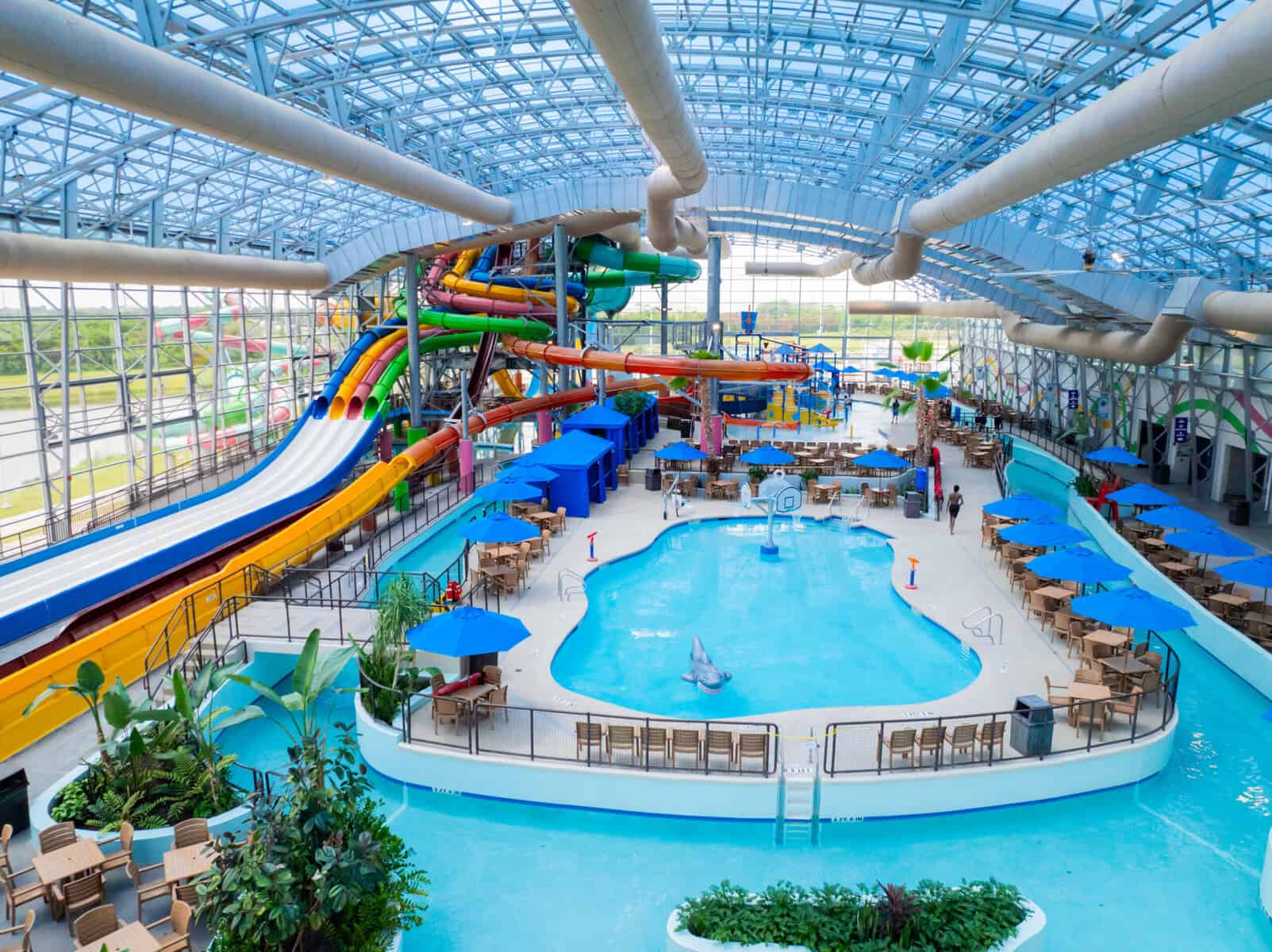 Aerial view of the indoor water park showing a lazy river, an activity pool and water slides.