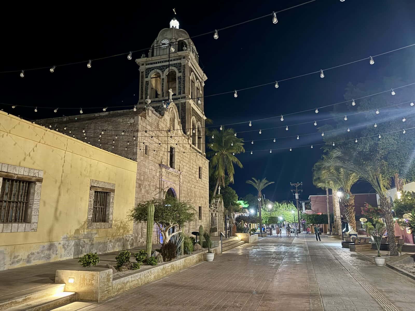 A Spanish colonial mission with bell tower at night