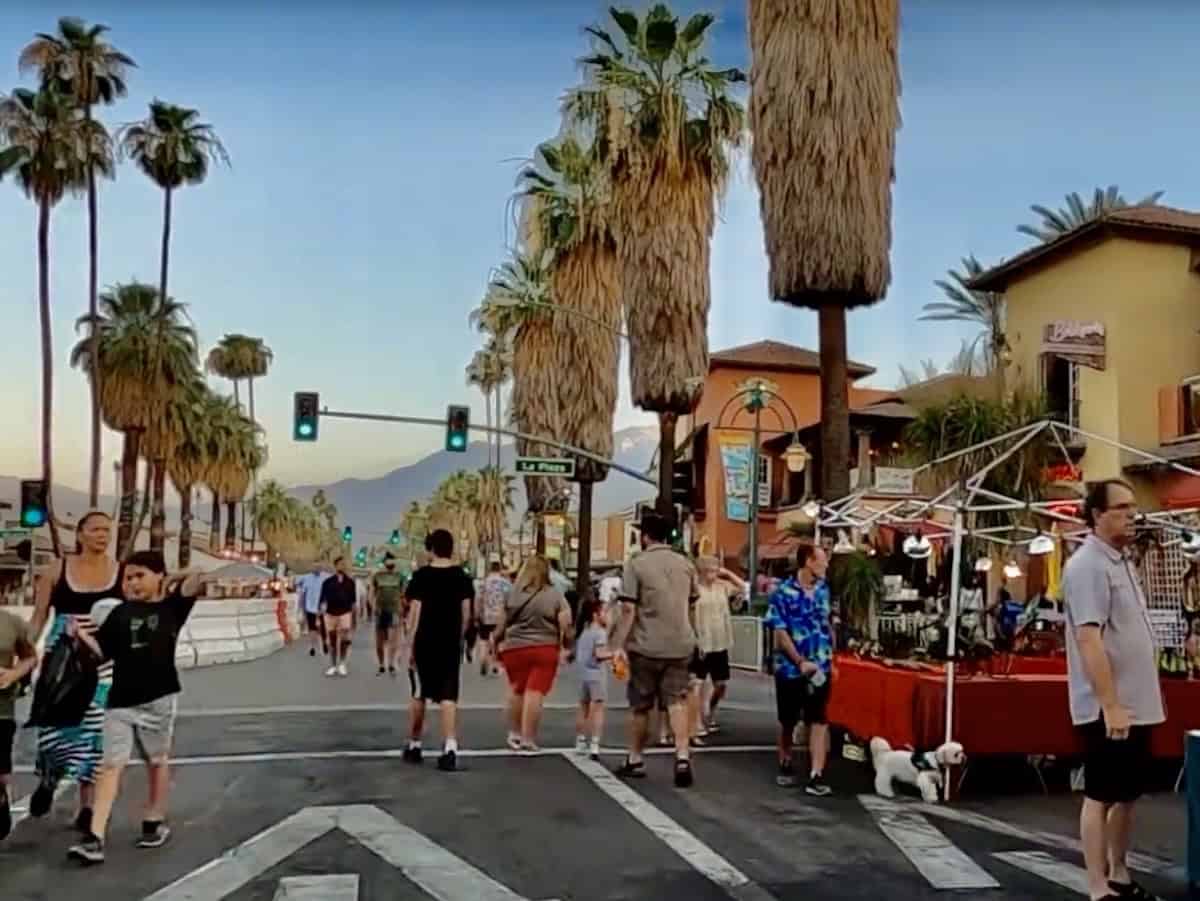 VillageFest on Palm Canyon Drive in downtown Palm Springs with vendors, food stalls and people walking at dusk