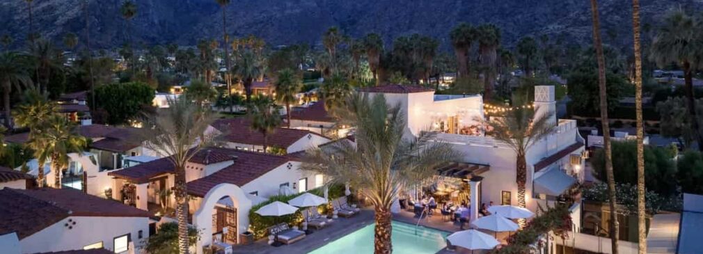 Aerial view of La Serena Villas at blue hour with pool illuminated.