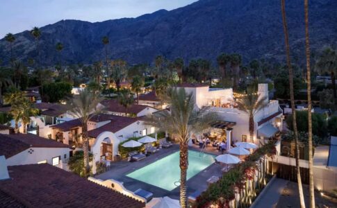 Aerial view of La Serena Villas at blue hour with pool illuminated.
