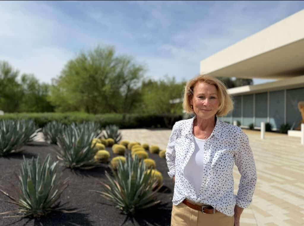 Woman with desert plants in front of Sunnylands Center & Gardens