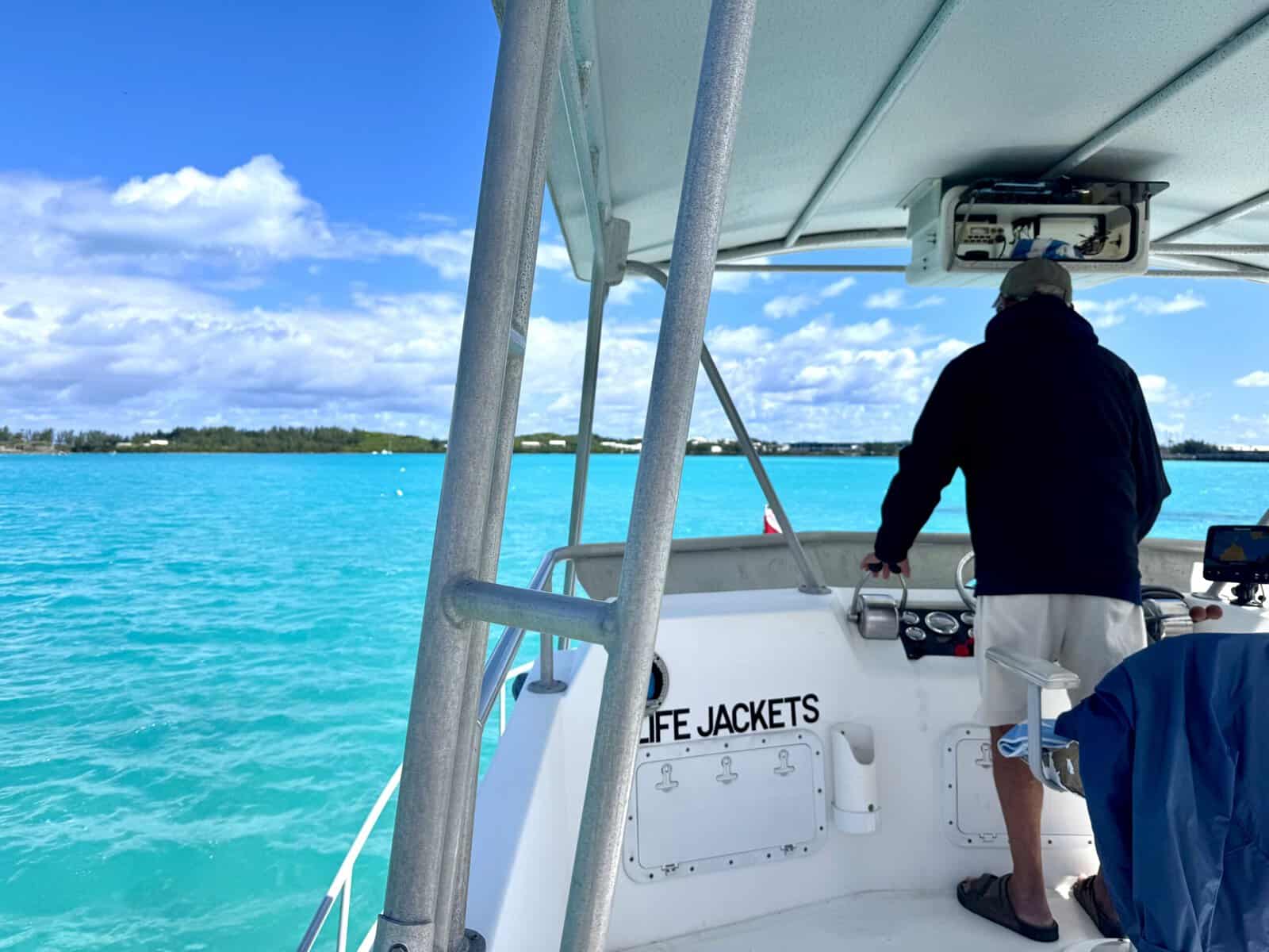 boat captain steers dive ship through striking blue-green water